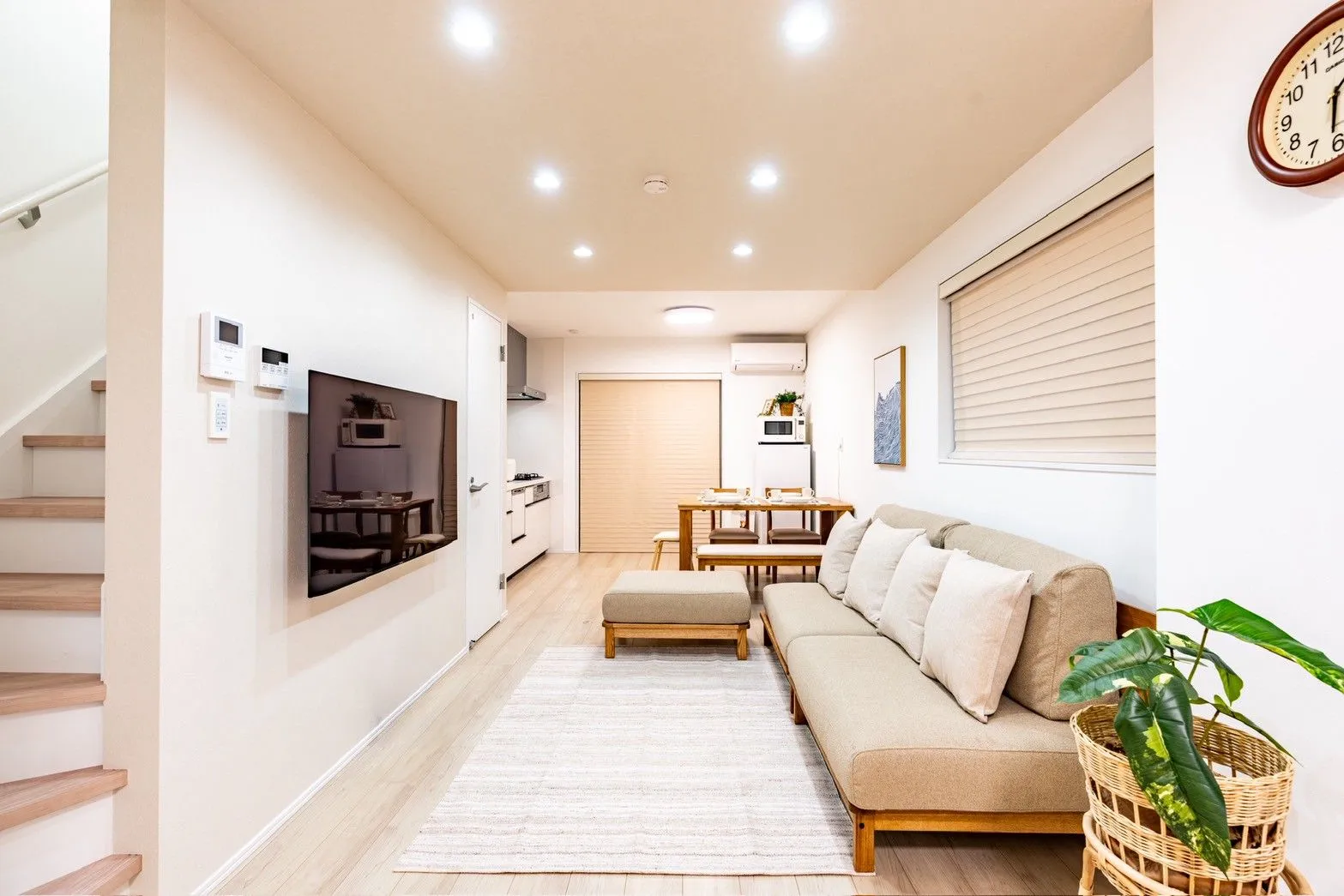 Warm wooden furnishings and an inviting living and dining area at AKI HOME
